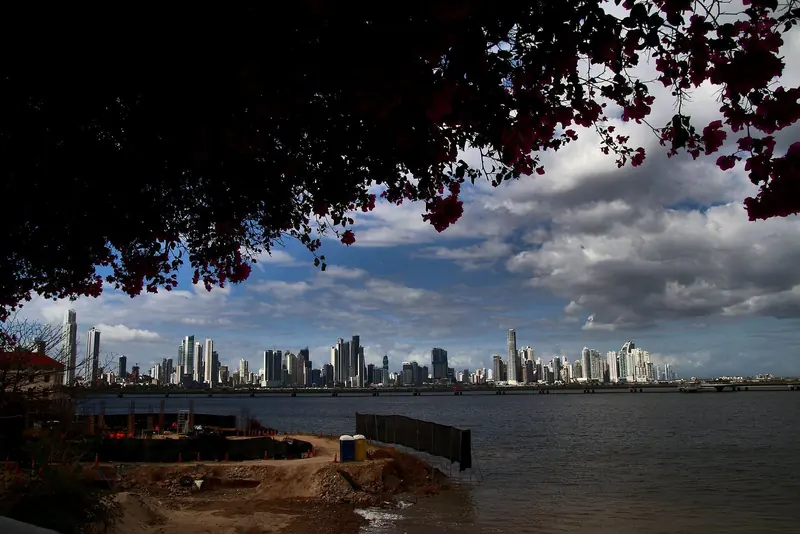The Panama City skyline across the bay at the Pacific end of the canal, two days from an empty reef anchorage including the transit.