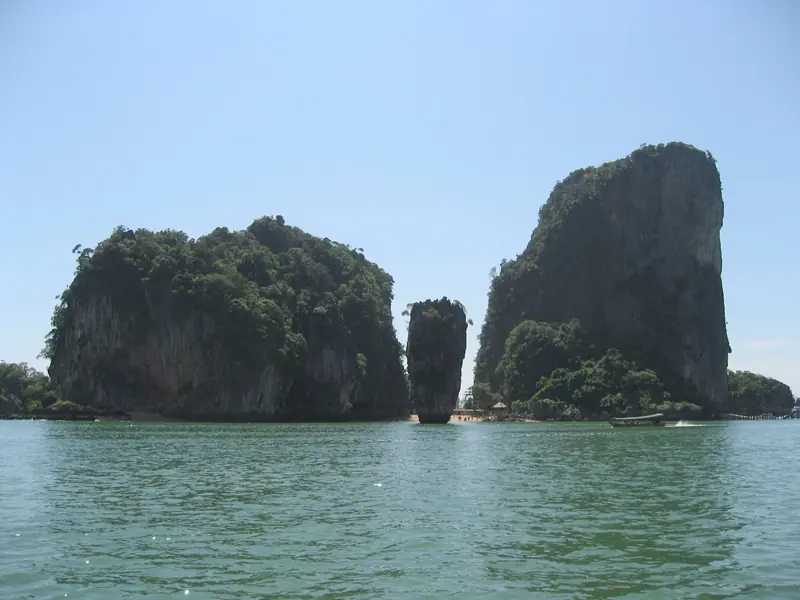 Limestone stacks rising vertically out of the bay, the formation that put this coast into every photograph of Thailand.