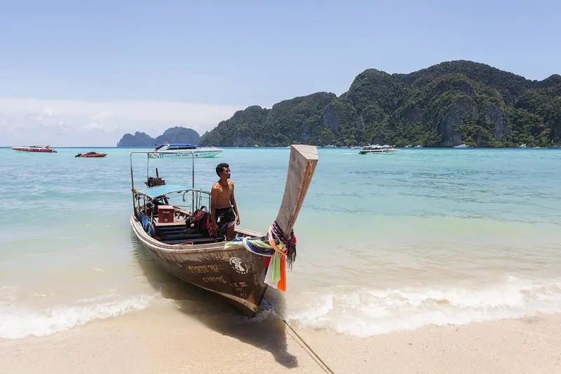 A longtail on a Phi Phi beach, where the national park charges a foreign visitor 400 baht to come ashore.
