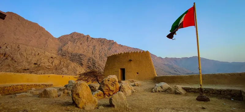 Dhayah Fort with the Hajar Mountains rising behind it, the range that continues north into Oman's Musandam peninsula.