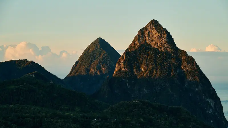 Gros Piton and Petit Piton at golden hour, the twin volcanic spires that anchor the Soufriere Marine Management Area.