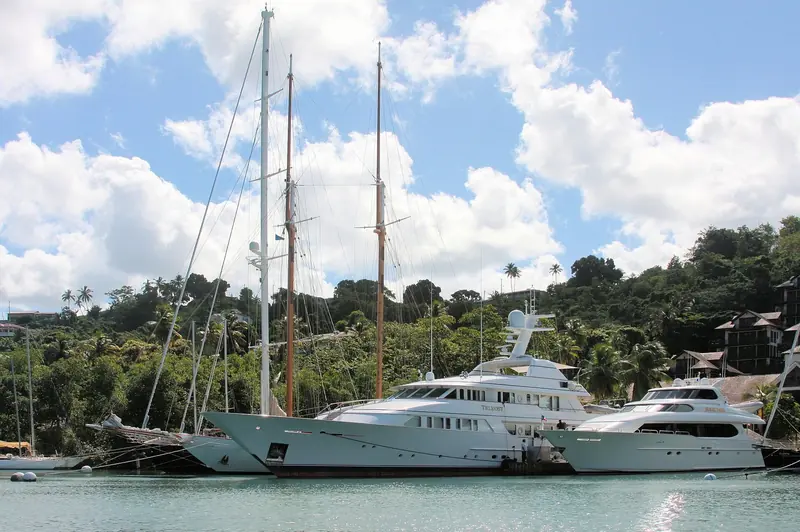 Yachts, including a large motor yacht, moored in Marigot Bay, Saint Lucia's classic hurricane hole.