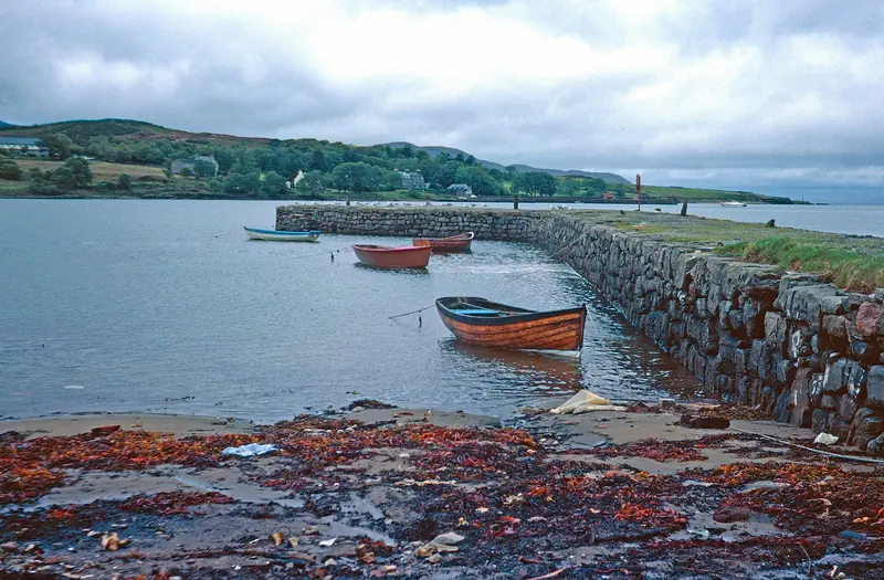 Boats left on the weed at low water beside a stone slipway, a reminder that springs here run four to five metres.