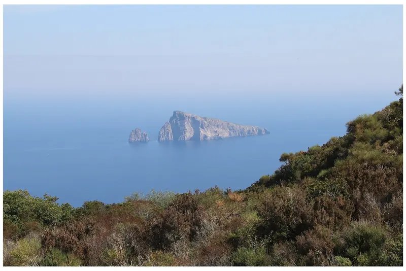 The view from Panarea towards Basiluzzo, the kind of water where the buoy fields sit because the volcanic bottom will not hold an anchor.