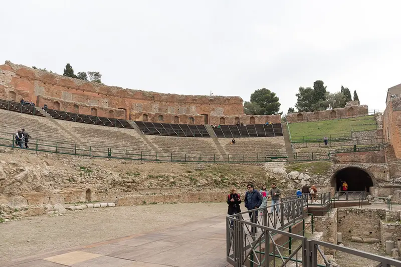 The Greek theatre at Taormina, which looks straight at Etna and is the one place on the coast where the yacht crowd and the land crowd overlap.
