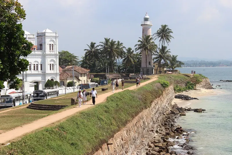 The Galle Fort ramparts and the 1939 lighthouse, the daymark every yacht calling Port Control on VHF 16 lines up on before entering the harbour below.