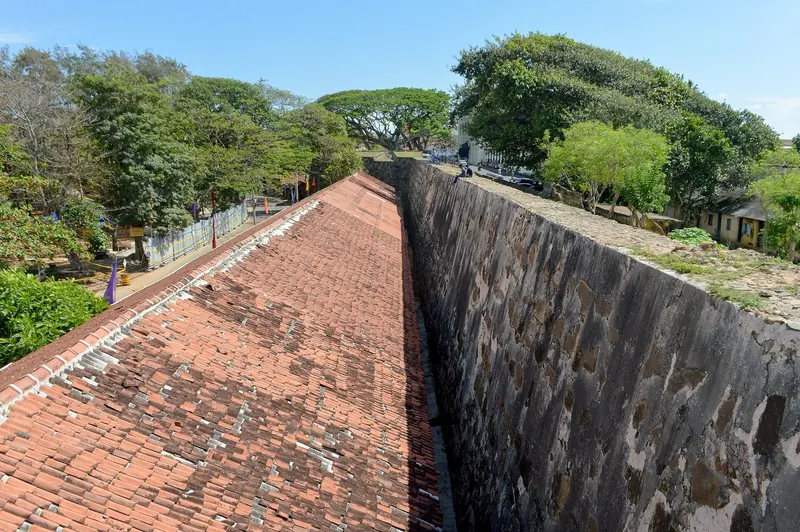 The Dutch-built ramparts that still enclose Galle Fort, walked by crews taking a break from the harbour's cement dust and surge a few hundred metres below.