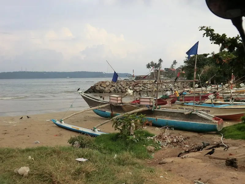 Outrigger fishing boats drawn up by Galle's breakwater, a reminder that the harbour a visiting yacht clears into is a working commercial and fishing port first.