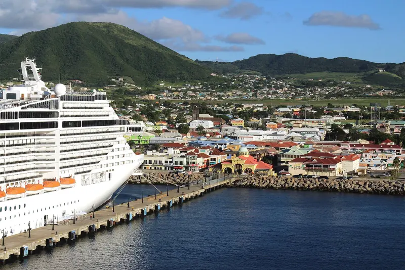 Basseterre's Port Zante harbour and the colourful waterfront town, with the island's volcanic hills behind.