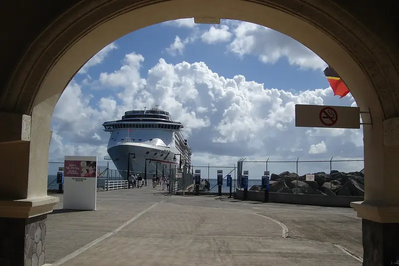 A cruise ship framed by the Port Zante arrival arch in Basseterre, the covered walkway cruise and yacht crews both use to reach the cleared port area.