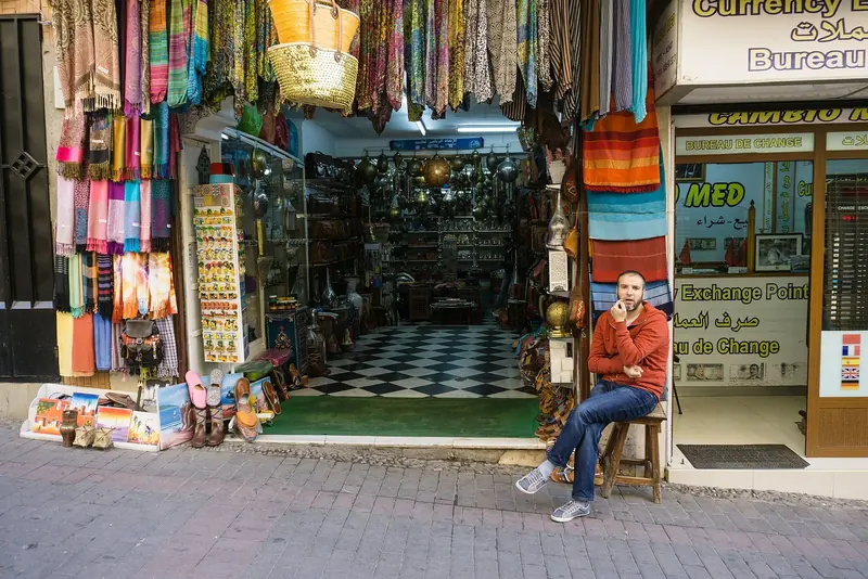 A street in the Tangier medina, still a working market of spice, leather and textile stalls rather than a tourist set piece.