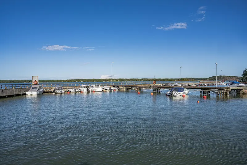 Small motor boats moored on buoys and pontoons at a guest harbour in Mariehamn, the Aland Islands.
