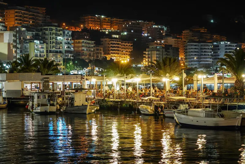 Saranda's waterfront promenade and harbour by night, the town's main provisioning and check-in stop for yachts on the Riviera.