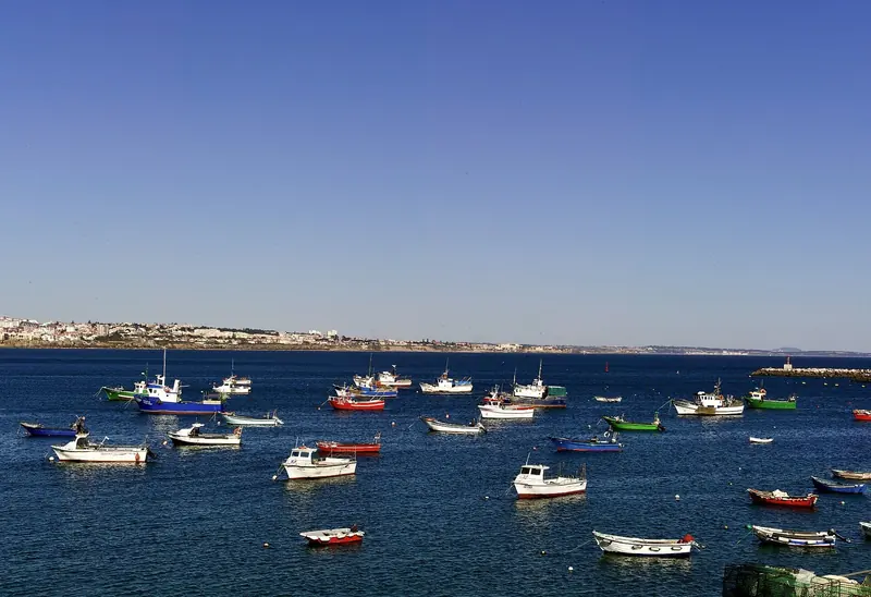 Fishing boats on moorings in Cascais bay, thirty minutes from Lisbon and the practical berth for a yacht visiting the capital.