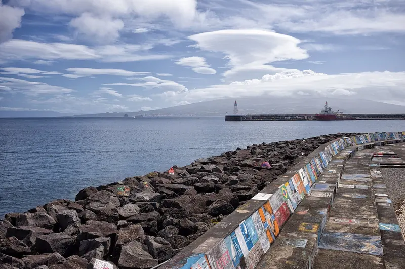 A lenticular cloud over Pico seen from the Horta breakwater, the painted mole in the foreground