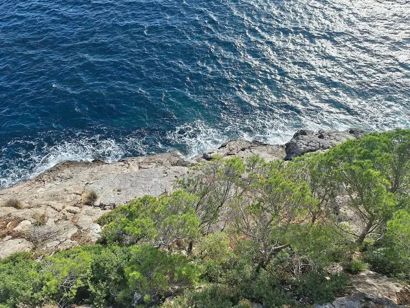 The rocky eastern coast of Mallorca, calas cut into low cliffs.