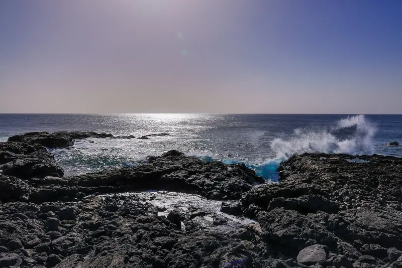 Atlantic swell breaks on black lava at the shoreline, the reason most bays here roll and the cruise runs harbour to harbour.