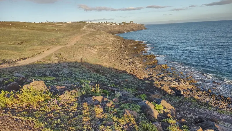 Low volcanic ground running out to the sea, the eastern islands being dry and lunar where the western ones are green.