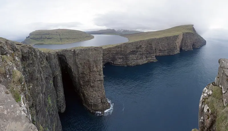 Sorvagsvatn, the lake that appears from this angle to hang above the sea on a cliff more than 30 metres up, one of the most photographed views in the islands and reachable only on foot.