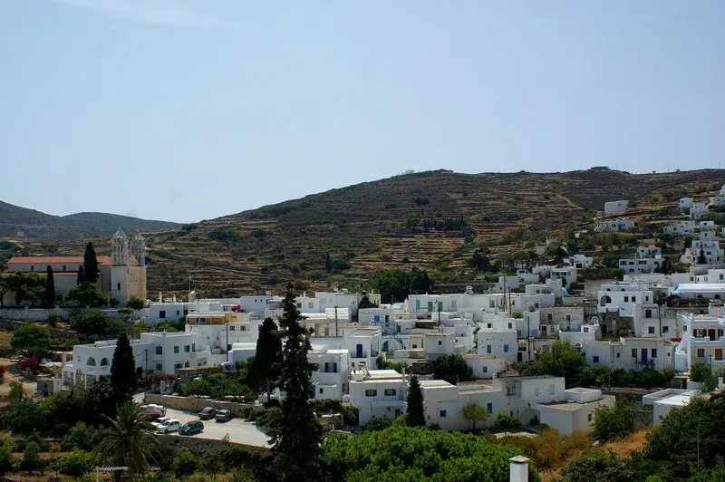 A Cycladic village above the sea, white and low against the hillside.