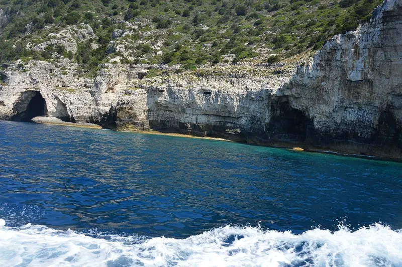 The Blue Caves on the Paxos coast, where the limestone is undercut into arches and the water goes from clear to indigo in a few metres.