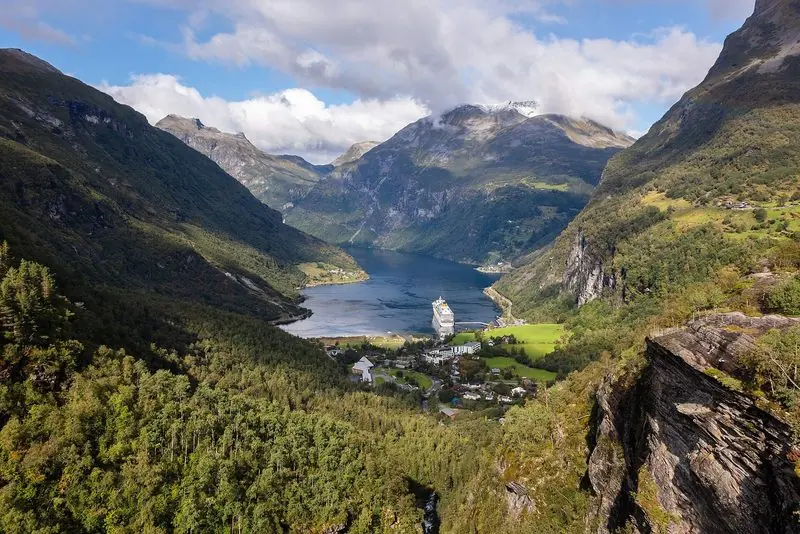Geirangerfjord ends in a small village with a single deep-water quay, a cruise ship taking most of it and steep farmland rising on both sides.