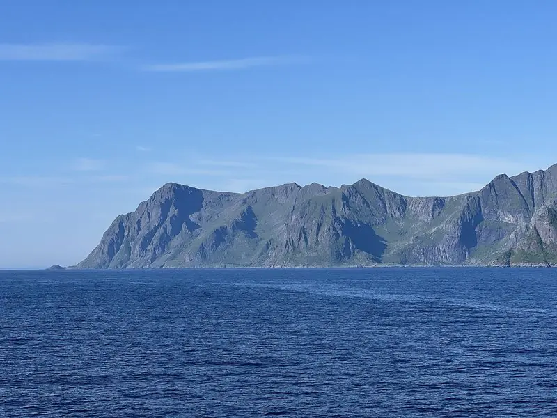 Open water off the Lofoten islands, where the mountain wall drops straight into the sea with no beach at its foot.
