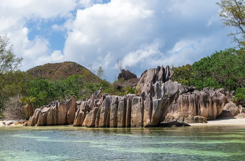Eroded granite at the water's edge, the exposed continental crust that makes these islands unlike any other group in any ocean.