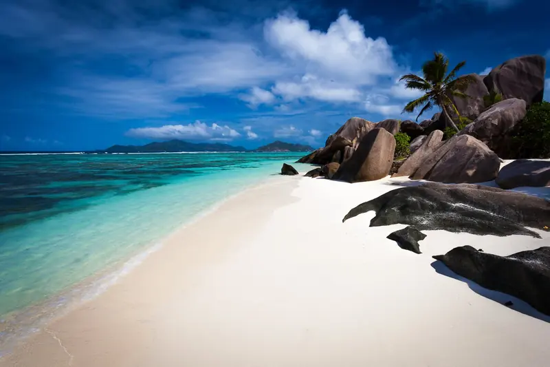 Palms and granite over a white beach, with sea temperature that runs 27 to 29 degrees all year round.