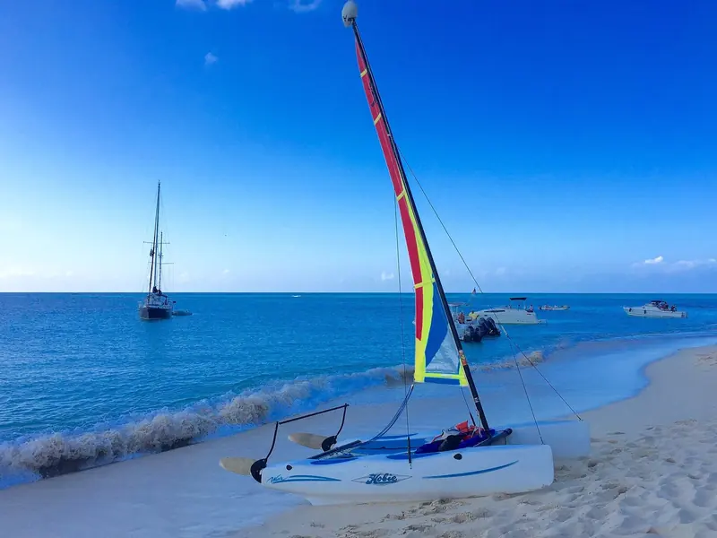 A beached Hobie Cat, a cruising sailboat on anchor and day boats rafted off Buck Island National Wildlife Refuge, two miles off St Thomas