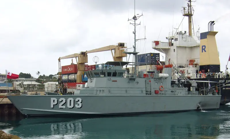 The Tongan Navy patrol boat VOEA Savea lies alongside a cargo ship in Neiafu harbour, the everyday traffic of Vava'u's only real port.
