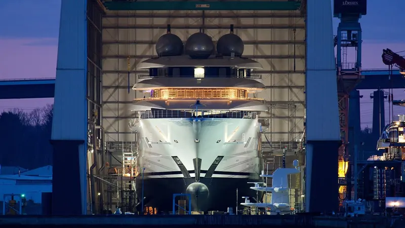 Amadea's bow inside Lurssen's covered construction hall at Rendsburg, Germany, shortly before her 2017 delivery. The yacht's entire build and sea-trial history sits with Lurssen, not with the US government that later seized her.