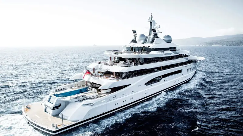 Amadea running broadside, showing the full length of a 106-metre, 4,402 GT hull built to carry 16 guests in eight suites with a crew of 36.