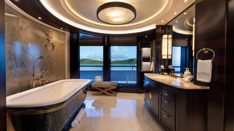 The master bathroom, with a freestanding tub and lacquered chinoiserie panel, was left largely as Reymond Langton designed it in 2014 before the 2025 refit touched the guest and social spaces.