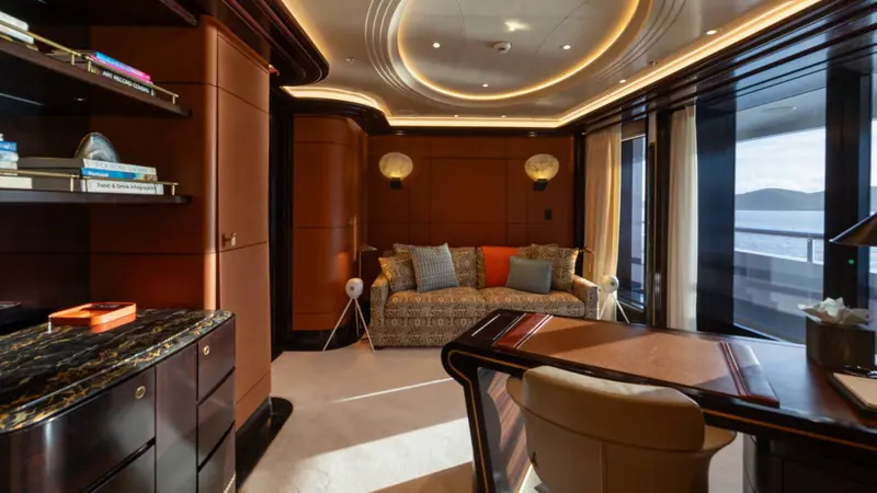 A private study off the owner's suite, panelled in warm timber. Whisper's full-beam master occupies its own deck with a separate office like this one.