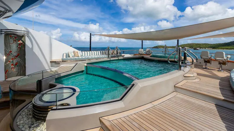 The sundeck pool and Jacuzzi, backed by a koi mosaic, form part of the wellness deck alongside a hammam, plunge pool and hair salon that charter guests pay up to EUR 1,200,000 a week to use.
