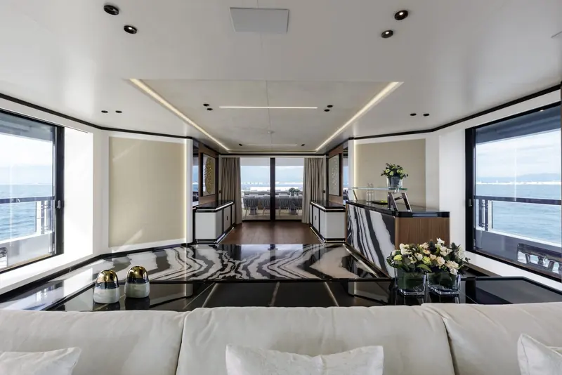 A GranSport 54 saloon looking aft, with full-height glazing to the side decks - the line accommodates up to ten guests in five staterooms.