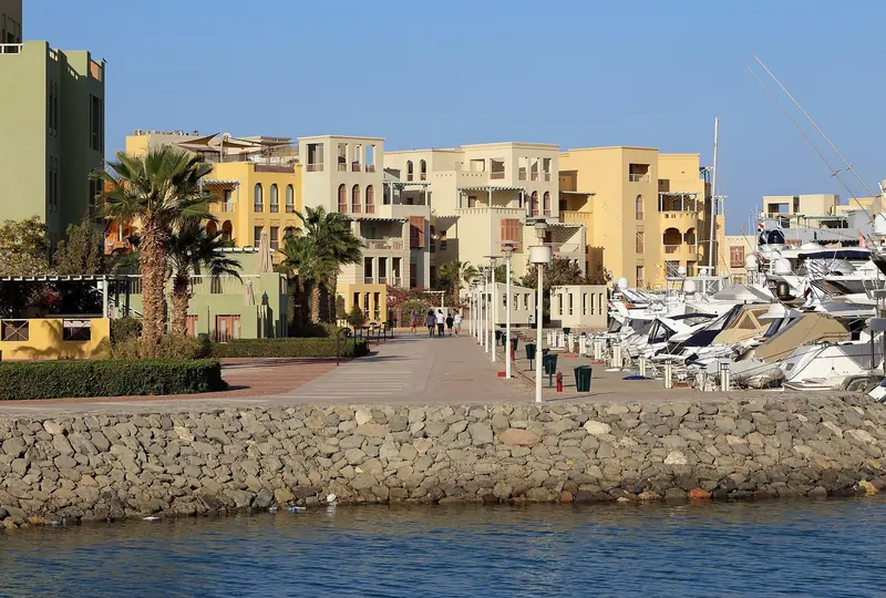 Sportfishing boats and motor yachts on the North Basin pontoons, backed by the pastel apartment blocks above the waterfront.