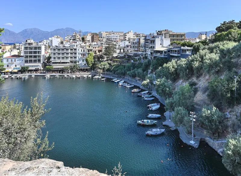 Boats moored along Lake Voulismeni's harbour wall in Agios Nikolaos.