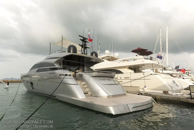 A Pershing 92, named on the hull, rafted alongside another motor yacht at Ao Po Grand Marina, the mooring style the marina uses for its larger sportscruisers.
