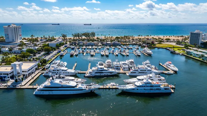 Megayachts on the outer dock with Fort Lauderdale beach directly across A1A, the reason Bahia Mar reads as a resort as much as a marina