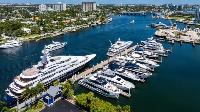 A megayacht and a line of sportfish and motor yachts sharing a finger pier, the everyday mix of vessel sizes the marina is built to handle