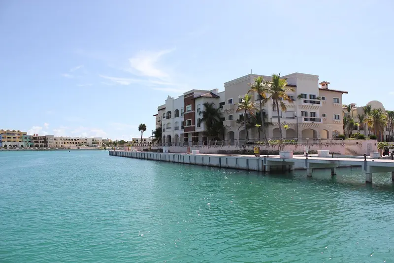 The marina's waterside apartment building and floating dock along the quay.