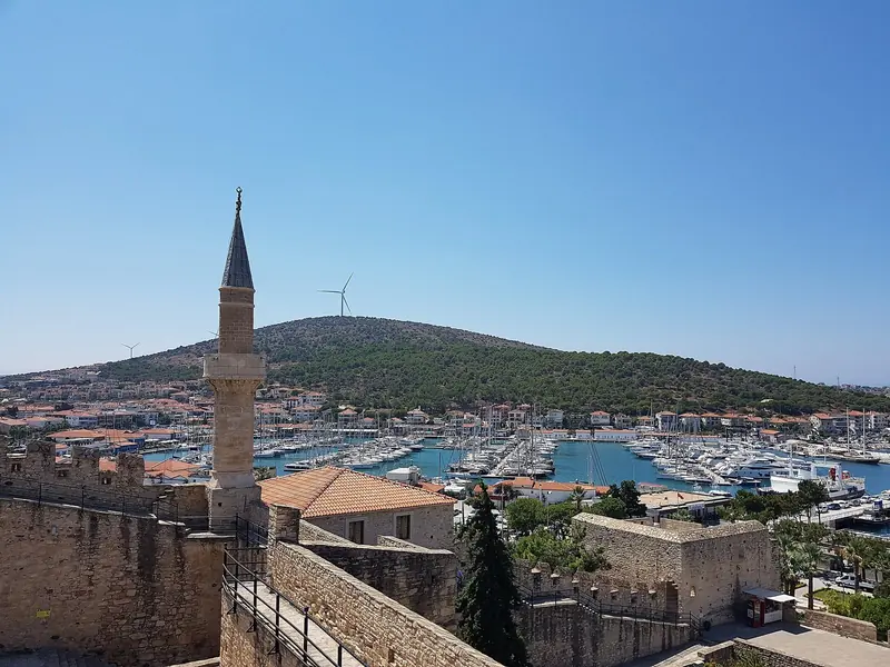 The marina seen from Cesme Kalesi, the Genoese fortress above the harbor, with the town's minaret in the foreground.