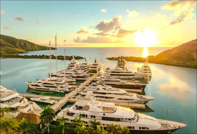 Superyachts stern-to at Christophe Harbour Marina at sunset, on the South East Peninsula of St Kitts.