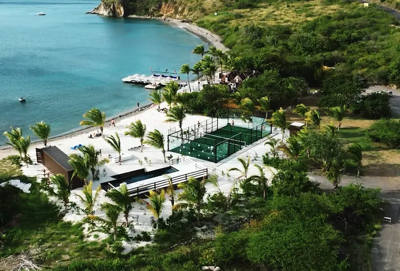 The padel courts and plunge pool at Pavilion Beach Club on Sandy Bank Bay, the white-sand beach nearest the marina.
