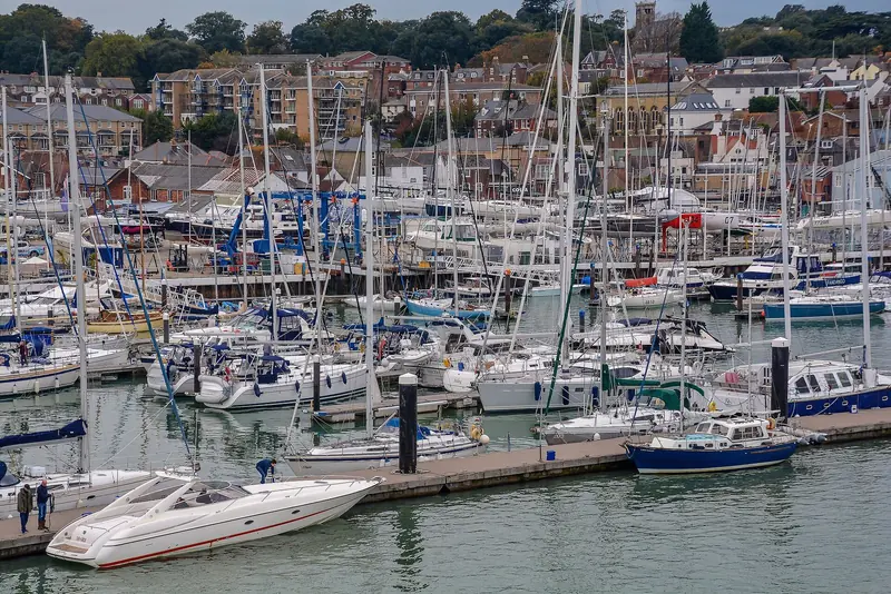 The Haven's berths run to the boatyard crane at the northern end, with Cowes rising up the hill behind the pontoons.