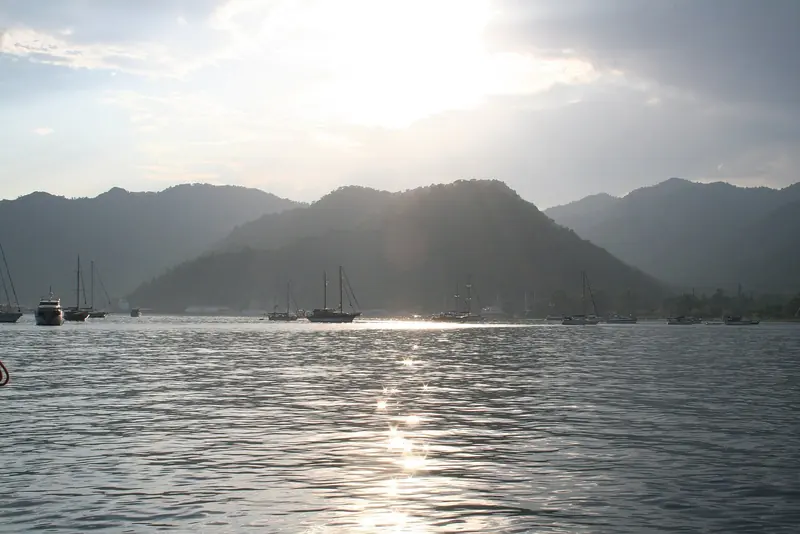Dawn over Gocek bay, gulets and motoryachts riding at anchor under the haze of the Taurus range.