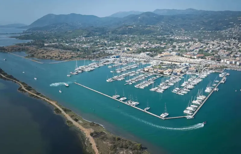 The marina seen from further out, the long spit that shelters the basin from the open Ionian.