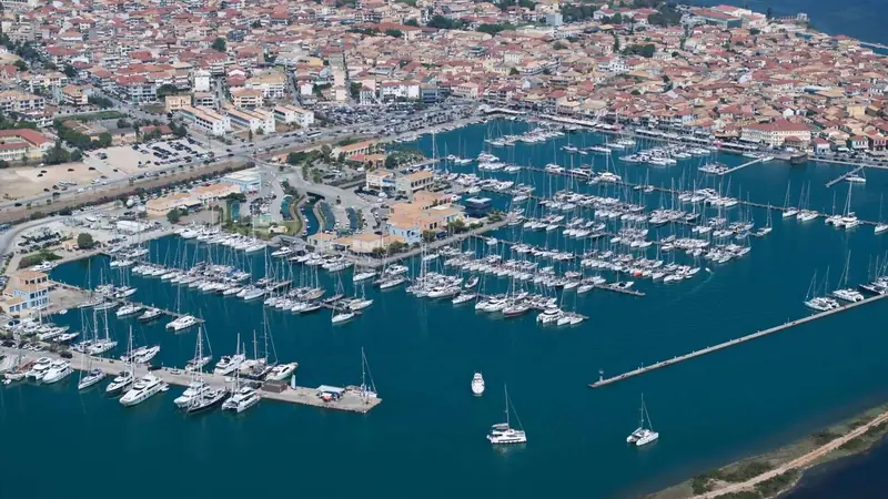 Berths filling the basin, the sailing and motor yacht fleet that bases here for Ionian charter typical of a July afternoon.